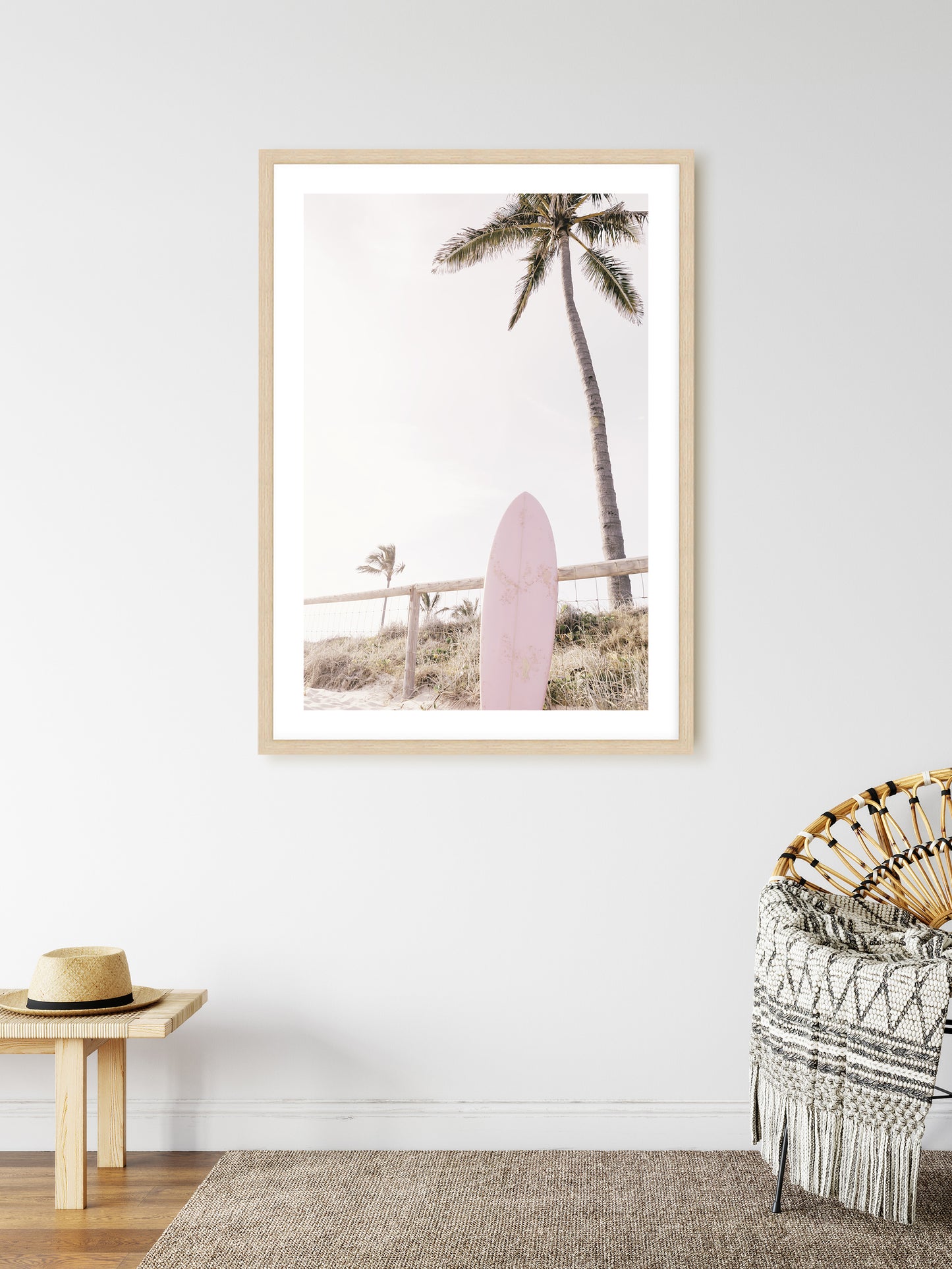 a picture of a pink surfboard hanging on a wall